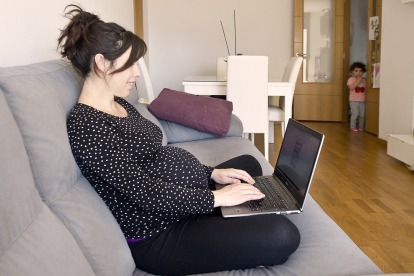 Una mujer embarazada consulta información en su ordenador portátil. ISRAEL L. MURILLO