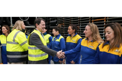 El presidente de la Junta, Alfonso Fernández Mañueco, saluda a las trabajadoras de Michelin durante su visita a la fábrica.- J. M. LOSTAU