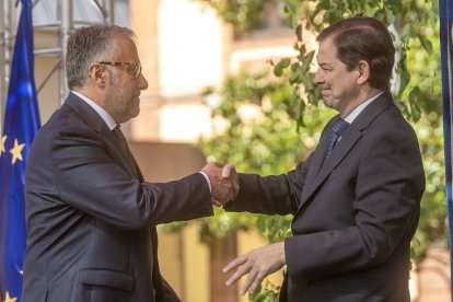 Carlos Pollán y Alfonso Fernández Mañueco se estrechan la mano en la toma de posesión del nuevo Gobierno de Castilla y León.