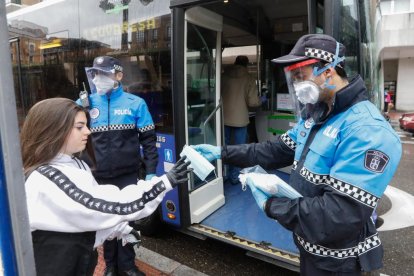 Policía reparte mascarillas a los usuarios del transporte urbano en la Plaza España de Valladolid. - JUAN MIGUEL LOSTAU