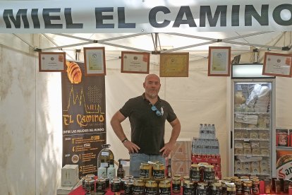 El ingeniero agrónomo Manuel Garrido Barros con sus mieles en una feria. / L.P.