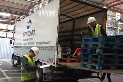 Un operario supervisa la carga y descarga de uno de los camiones de la flota de Recytronica.