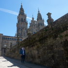 Un peregrinos con mascarillas se marcha de la Plaza del Obradoiro, mientras que otro llega, en el primer verano de la pandamia Covid-19, Santiago de Compostela 26 de agosto del 2020 - Europa Press.