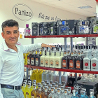 Jerónimo Panizo posa frente a sus productos en la tienda de la fábrica de Orujos Panizo./ ARGICOMUNICACIÓN.