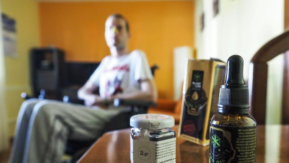 El joven vallisoletano Rubén, con un aceite de cannabis que toma para paliar los dolores que le provoca la Esclerosis Lateral Amiotrófica que padece. MIGUEL ÁNGEL SANTOS (PHOTOGENIC)