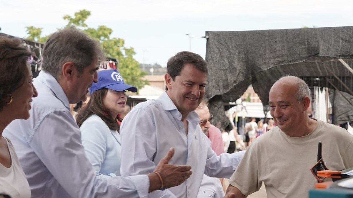 El presidente del Partido Popular de Castilla y León, Alfonso Fernández Mañueco, visita Íscar (Valladolid) junto al presidente provincial del PP, Conrado Íscar, y la número uno al Congreso por esa provincia, Mercedes Cantalapiedra y visitan el mercadillo de la localidad. -ICAL