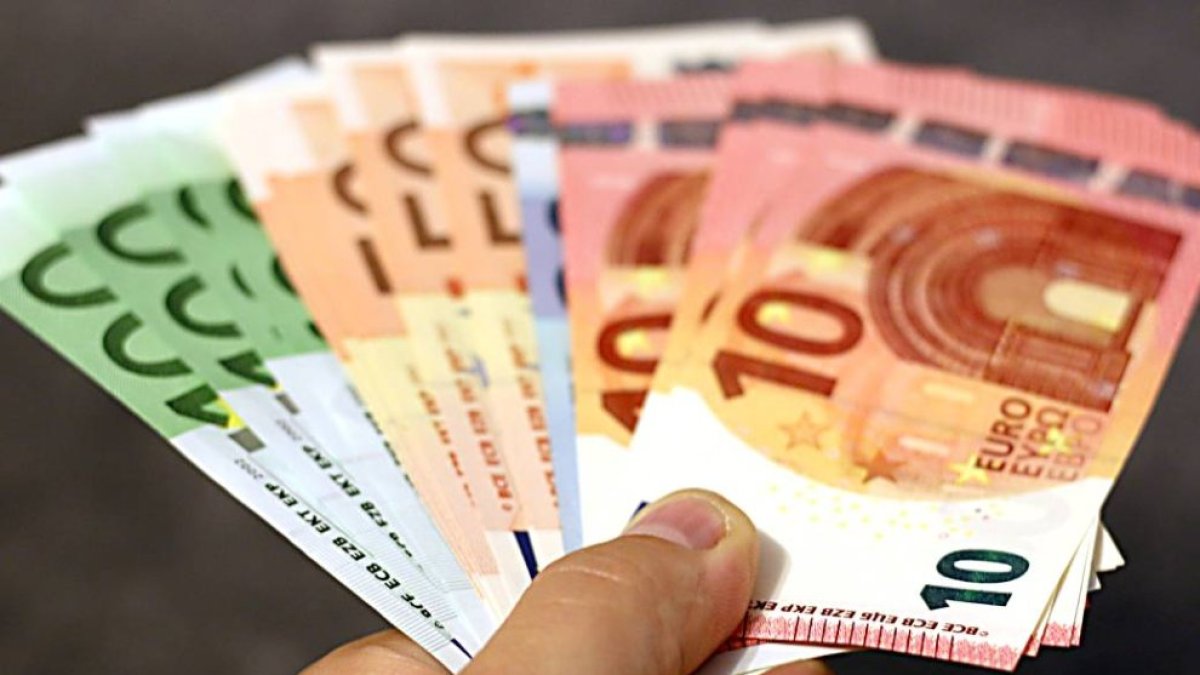 Un ciudadano sostiene billetes.